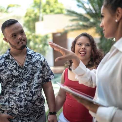 A professional woman talking to a young man and a young woman - WorkReady Launchpad employment program, NDIS capacity building, and person‑centred career support services.